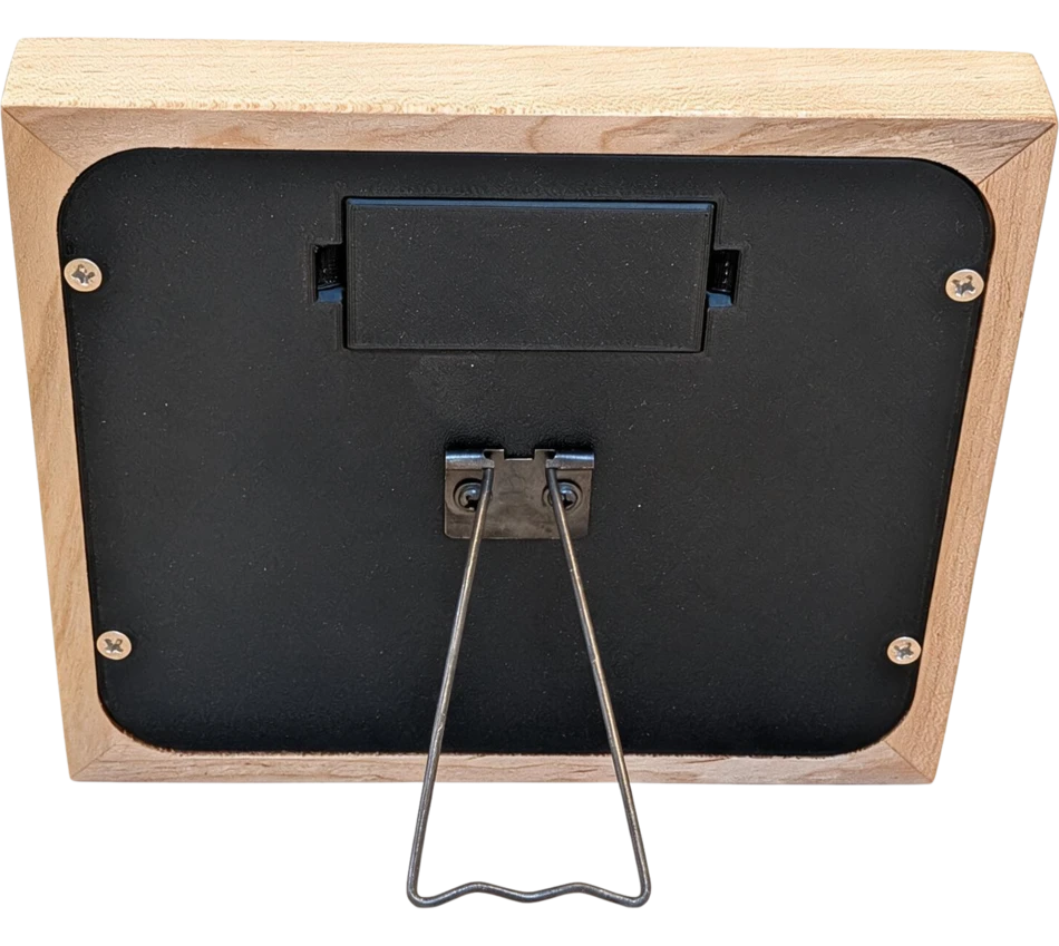 The back of Mindrise in oak, showing the battery door and the fold-out stand