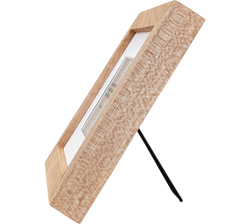 Mindrise in oak, seen from the side on its fold-out stand, showing how slim the frame is
